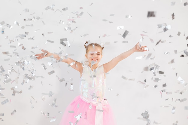 Concepto de fiesta, vacaciones, cumpleaños, año nuevo y celebración - Niño lindo lanzando confeti.