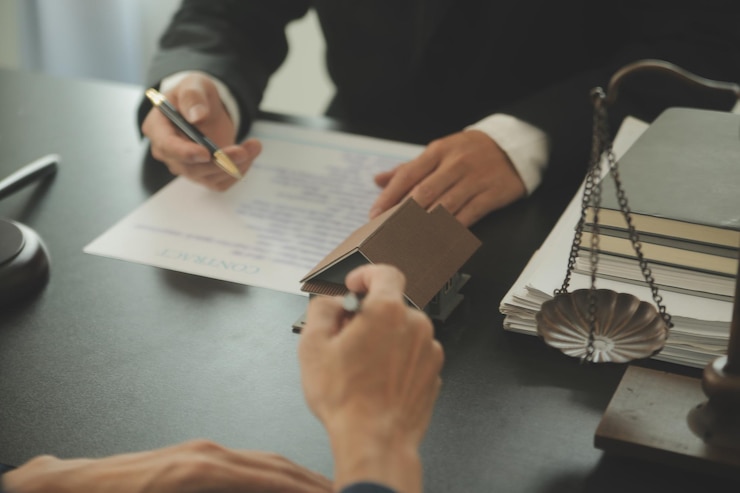 Foto concepto de justicia y derecho el asesor legal presenta al cliente un contrato firmado con mazo y derecho legal o una reunión de equipo legal en el bufete de abogados en segundo plano.