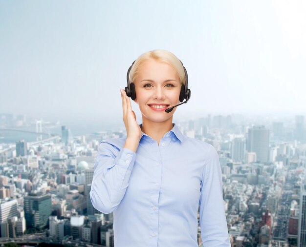 concepto de negocio, tecnología y centro de llamadas - operador de línea de ayuda femenina amable con auriculares