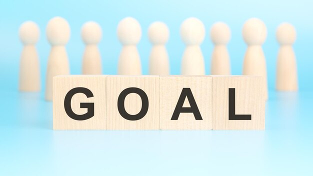 concepto de negocios y finanzas en la superficie azul hay figuras de madera y cubos con la inscripción GOAL