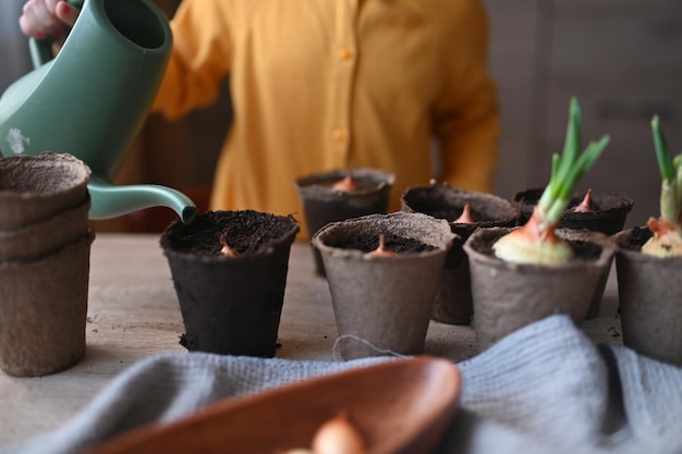 El concepto de niña de jardinería se dedica a plantar semillas para plántulas que vierten tierra en macetas para cultivar