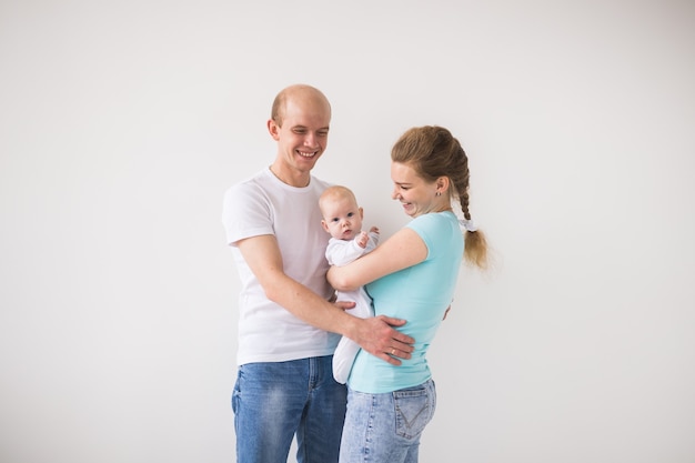 Concepto de paternidad, amor y familia - madre sonriente y padre sosteniendo a su hija.