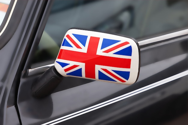 Concepto de patriotismo británico. Espejo lateral de un coche de época con la bandera del Reino Unido en extreme closeup