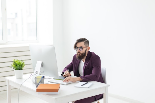 Concepto de personas y tecnología hombre atractivo con barba vestido con chaqueta púrpura trabajando en el