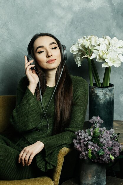 Concepto de personas y tecnología mujer feliz en auriculares escuchando música desde el teléfono inteligente