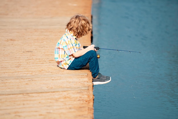 Concepto de pesca niño pescando en el lago joven pescador con spinner en el río retrato de emocionado