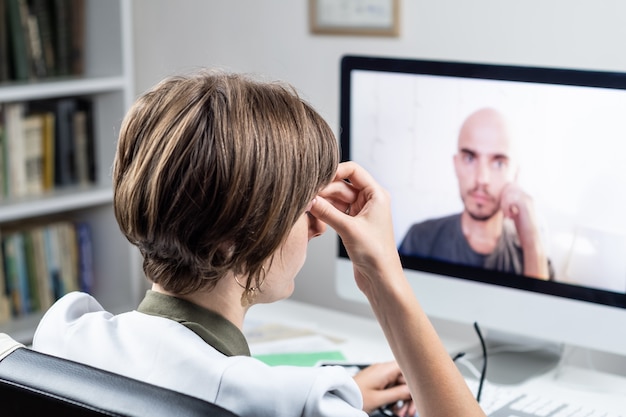 Concepto de salud digital: médico en ejercicio con cita en línea con un paciente. Médico que consulta a una persona mediante un sistema de conferencias web