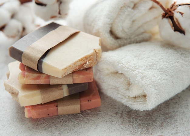 Concepto de spa con jabón natural orgánico hecho a mano flores de algodón y toallas de masaje