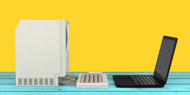 Concepto de tecnología informática. La unidad del sistema, el monitor, el teclado y el mouse frente a la computadora portátil moderna en una mesa de madera. Representación 3D