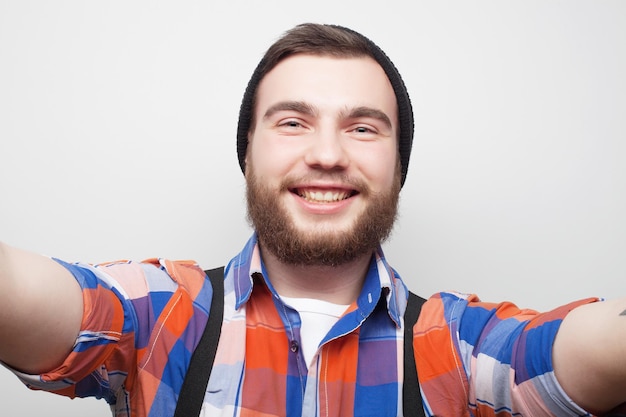 Concepto de tecnología Selfie feliz Joven guapo con cámara y haciendo selfie y sonriendo