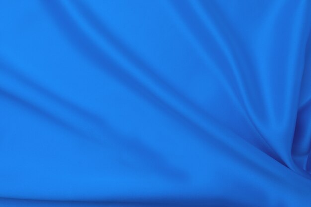 Concepto de textil y textura de color azul clásico de moda. Muestra de tela de seda ondulada de color azul clásico - primer plano.