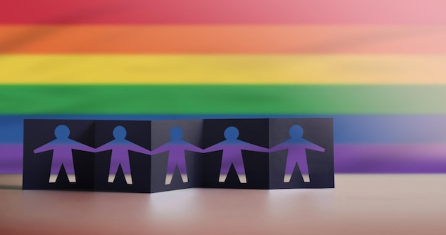 Conceptos LGBTQ Mes del orgullo Signo de género Derechos humanos y papel de protesta cortado como grupo de personas cogidos de la mano Bandera del arco iris del orgullo borroso como fondo