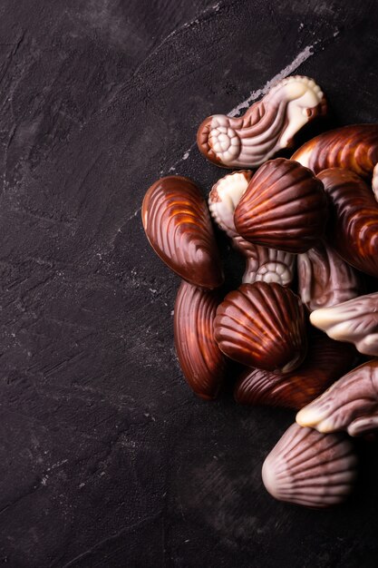 Conchas de chocolate belga sobre una mesa negra