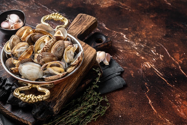 Conchas de vino blanco de ajo Almejas vongole en una sartén con hierbas Fondo oscuro Vista superior Espacio de copia