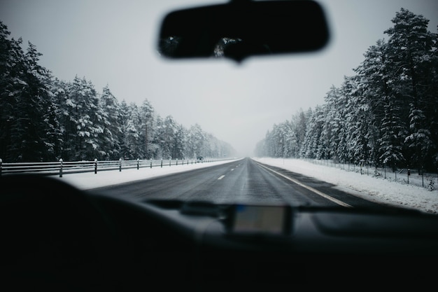 Foto conducir por una carretera nevada en invierno en un coche vista interior