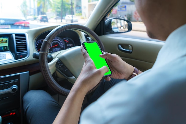 Conducir coche y usar el teléfono. Conductor distraído enviando mensajes de texto con teléfono móvil. Hombre irresponsable revisando el mensaje con un teléfono inteligente en el tráfico. Concepto de accidente automovilístico. Sosteniendo el dispositivo inteligente en la mano.