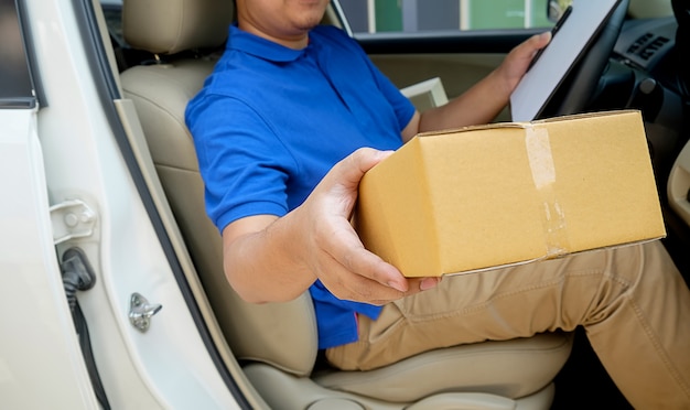 Foto conductor de entrega conduciendo con paquetes en el asiento.