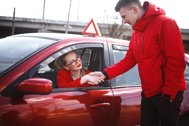 El conductor es un instructor de autoescuela y una estudiante en un auto de examen.