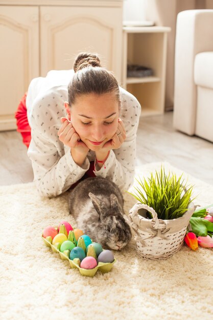 Conejo de Pascua en casa con huevos y pasto verde