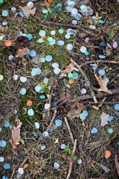 Confete colorido na grama na floresta depois da festa Não há mais plástico para salvar o planeta Poluição de confete