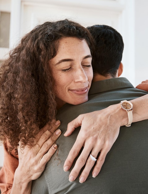 Foto confiança feliz e um casal se abraçando em sua casa para apoio, cuidado ou romance no casamento juntos paz, amor e segurança com uma mulher abraçando seu marido em sua casa para criar laços de relacionamento