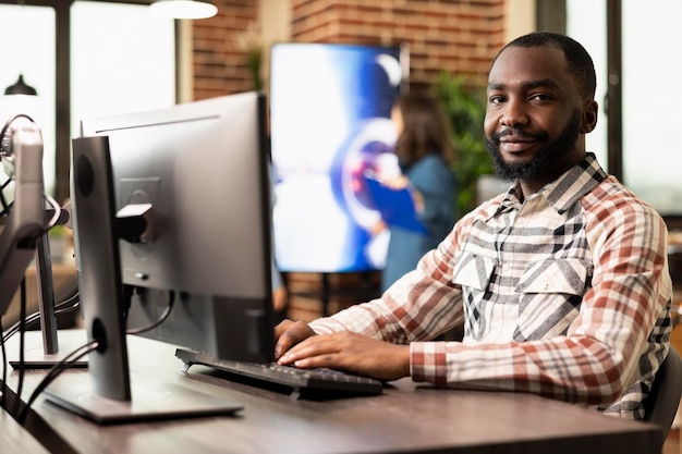 Confident man poses for camera in office