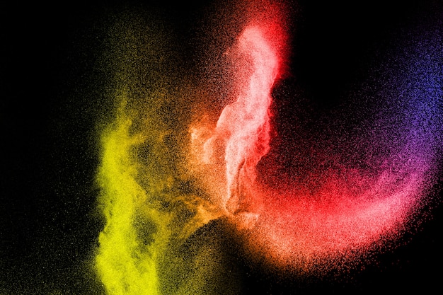 Congelar el movimiento de las partículas de polvo de color sobre fondo negro. Textura de superposición de polvo de color abstracto.