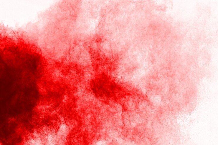 Foto congele o movimento do pó vermelho que explode, isolado no fundo branco.