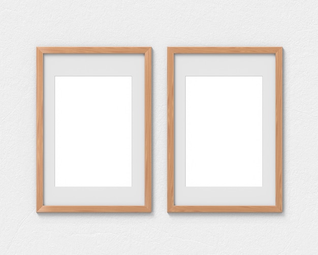 Conjunto de 2 maquetas verticales de marcos de madera con un borde colgado en la pared. Base vacía para imagen o texto. Representación 3D