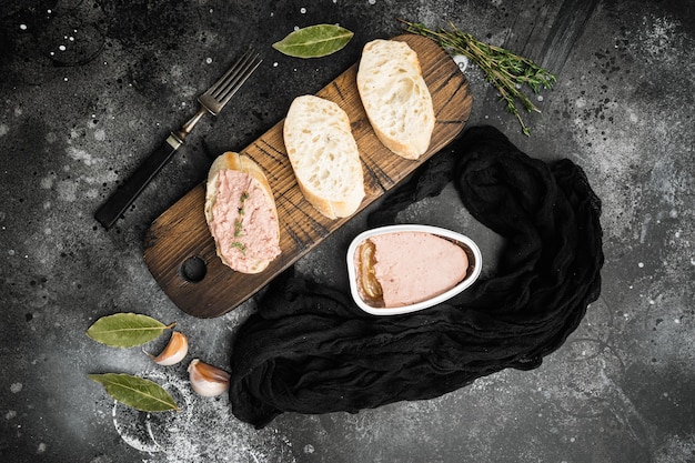Conjunto de baguette de sándwich de paté de hígado de pollo, sobre fondo de mesa de piedra oscura negra, vista superior plana
