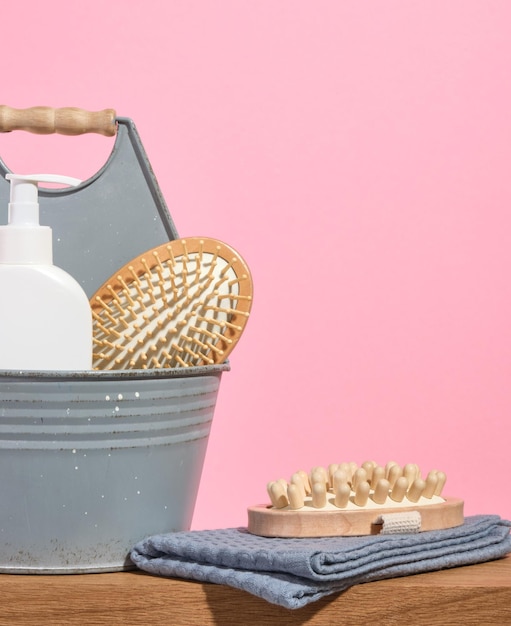 Conjunto de diferentes artigos de higiene ecológicos sobre um fundo rosa toalha de banho limpa escova de massagem de pente de cabelo Copiar espaço para texto