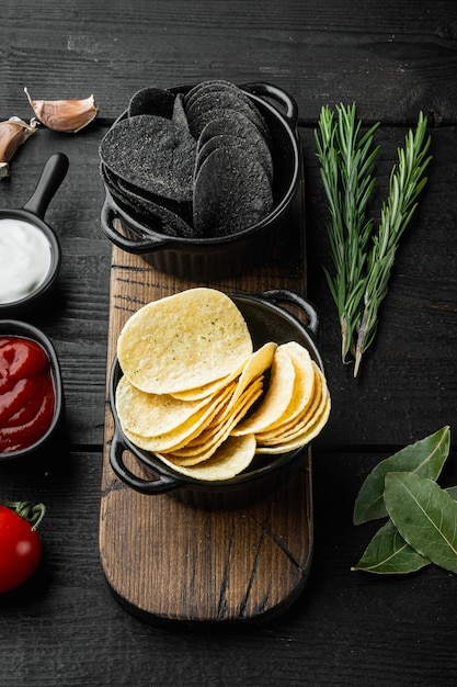 Conjunto de diferentes batatas fritas de variação, em madeira preta