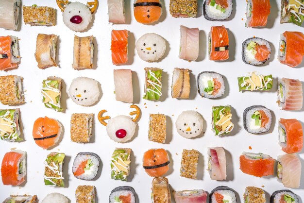 Conjunto de sushi de Natal com rolinhos decorados de forma divertida como os símbolos de Natal ÃƒÂƒÃ‚Â ¢ ÃƒÂ‚Ã‚Â € ÃƒÂ‚Ã‚Â “papai noel, cervo, boneco de neve, árvore do abeto, menu de sushi bar de Natal, maquete de entrega festiva