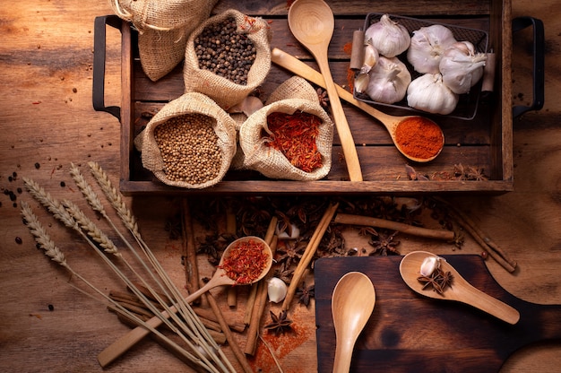 Conjunto de vista superior de especiarias e ervas na bandeja de madeira, alimentos e ingredientes da culinária.