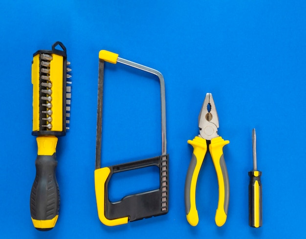 Un conjunto de herramientas para reparar aislado sobre un fondo azul con un espacio para publicidad.
