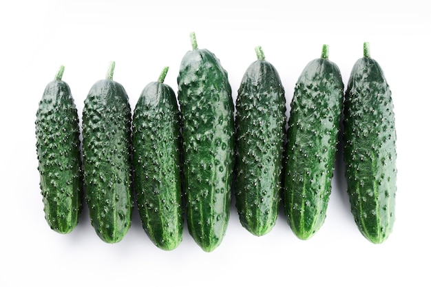 Conjunto de pepinos enteros frescos aislado sobre un fondo blanco, trazado de recorte. Diseño de fondo de papel tapiz de pepino de jardín