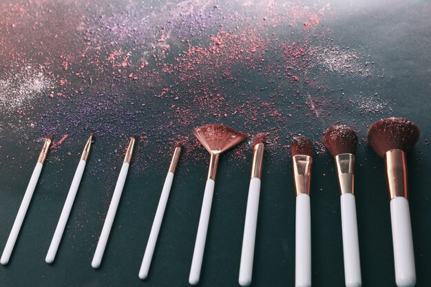 Conjunto de pinceles de maquillaje cosmético de diferentes mujeres profesionales.