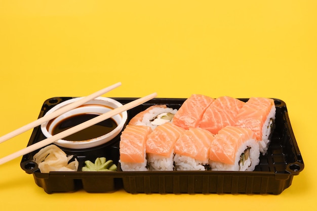 Conjunto de sushi sobre fondo amarillo con lugar para texto