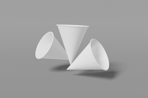 Conjunto de tres tazas de papel blanco en forma de cono volar sobre un fondo gris