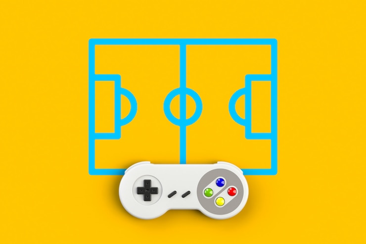 Foto consola de videojuegos gamepad en el campo de fútbol