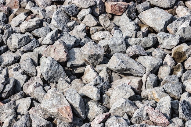 Construção de estradas pedra cascalho granito pedra Pedra britada close-up Pequenas rochas chão Pedra britada material de construção de estrada cascalho textura Pequena pedra material de construção rocha