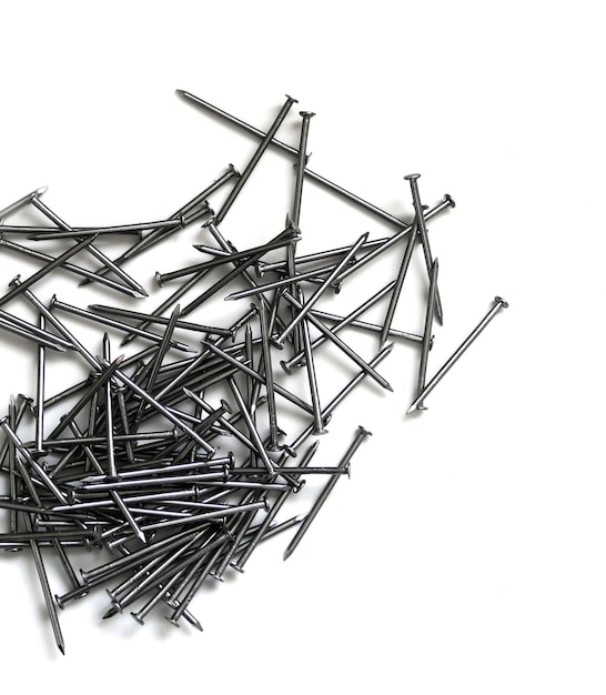 La construcción clava una gran cantidad de clavos en un fondo blanco