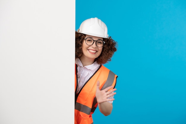 Constructor femenino de vista frontal en uniforme en el azul