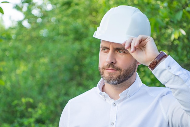 Construtor de homem usando capacete de segurança ao ar livre espaço de cópia de fundo natural