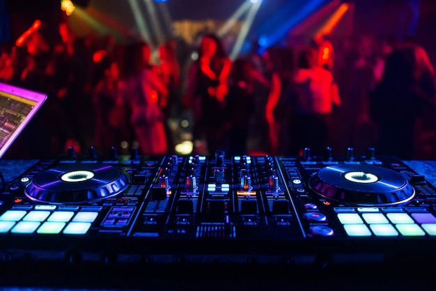 Controlador de música DJ mezclador en una discoteca en una fiesta