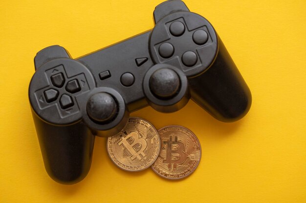 Controlador de videojuegos de concepto de juego criptográfico con una moneda de criptomoneda bitcoin