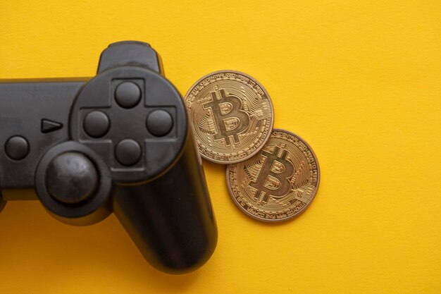 Controlador de videojuegos de concepto de juego criptográfico con una moneda de criptomoneda bitcoin