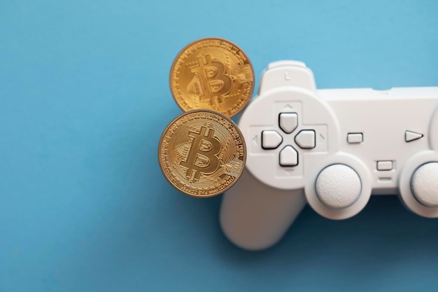 Controlador de videojuegos de concepto de juego criptográfico con una moneda de criptomoneda bitcoin
