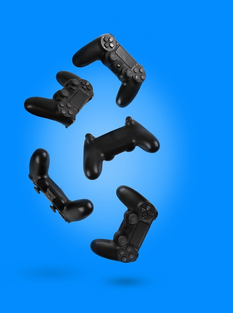 Foto controladores de videogame isolados em um fundo de cor azul.