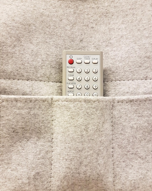 Controle remoto de TV guardado em um bolso de pano pendurado